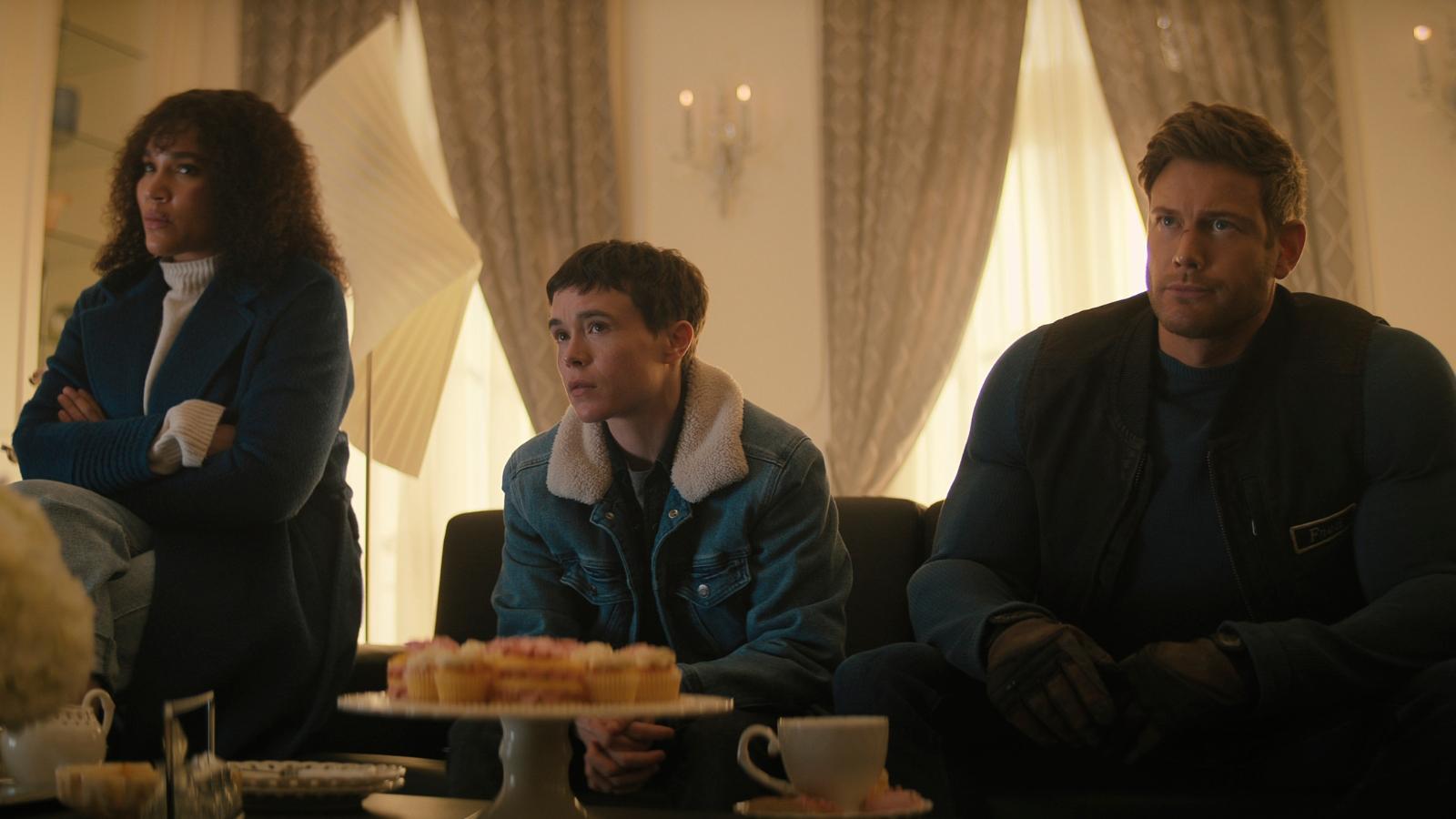 trois personnes (alison, viktor et luther) installées dans des canapés face à des petits fours dans the umbrella academy